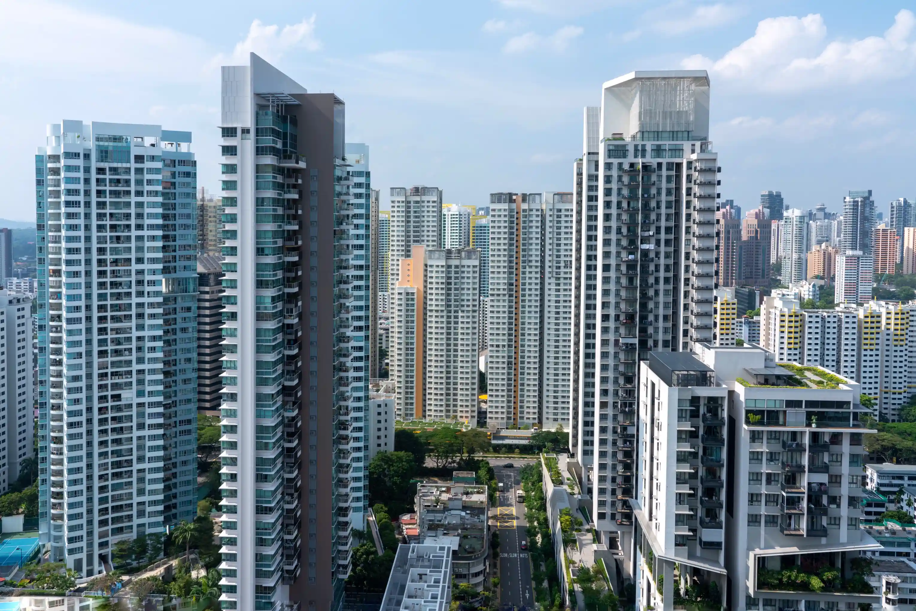 Aerial view of dense high-rise residential and commercial towers in a compact urban district